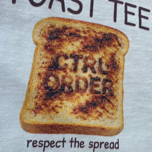 close up of Toast design with text on a bone background