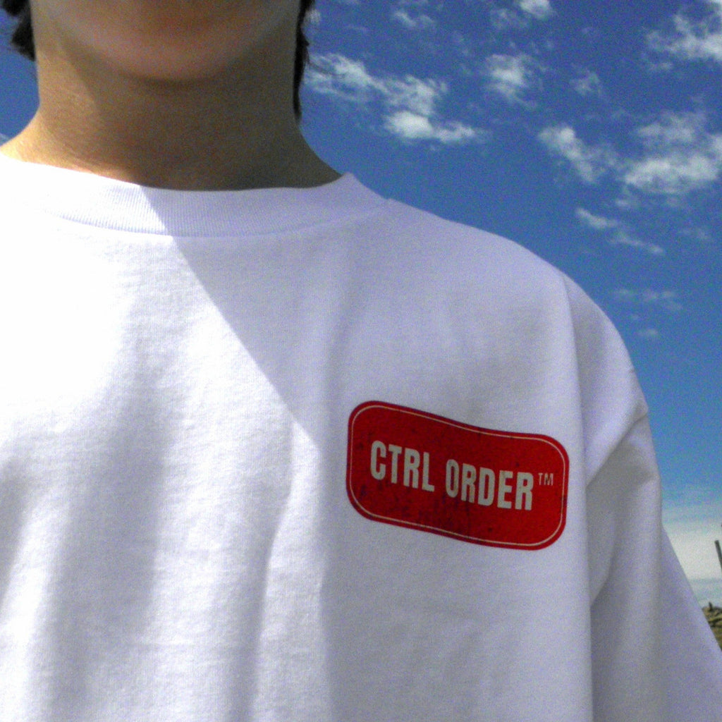 White Certified Street Dinner t-shirt with red CTRL ORDER chest logo worn outdoors