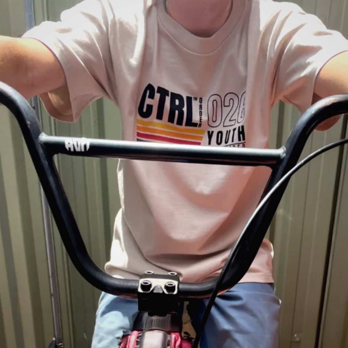 Youth wearing bone Youth Engineered Stripe tee in lifestyle setting - minimal kids streetwear by CTRL ORDER Australia