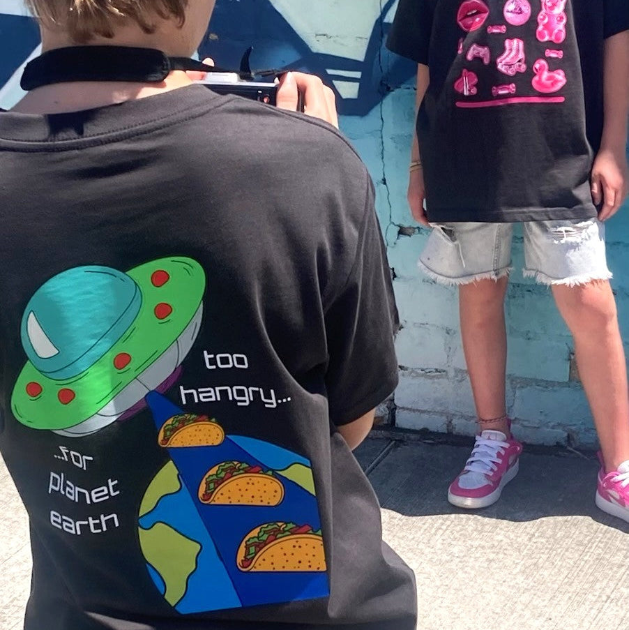 Youth models wearing Alien Taco black t-shirts showing UFO and taco back graphic - Australian kids streetwear by CTRL ORDER